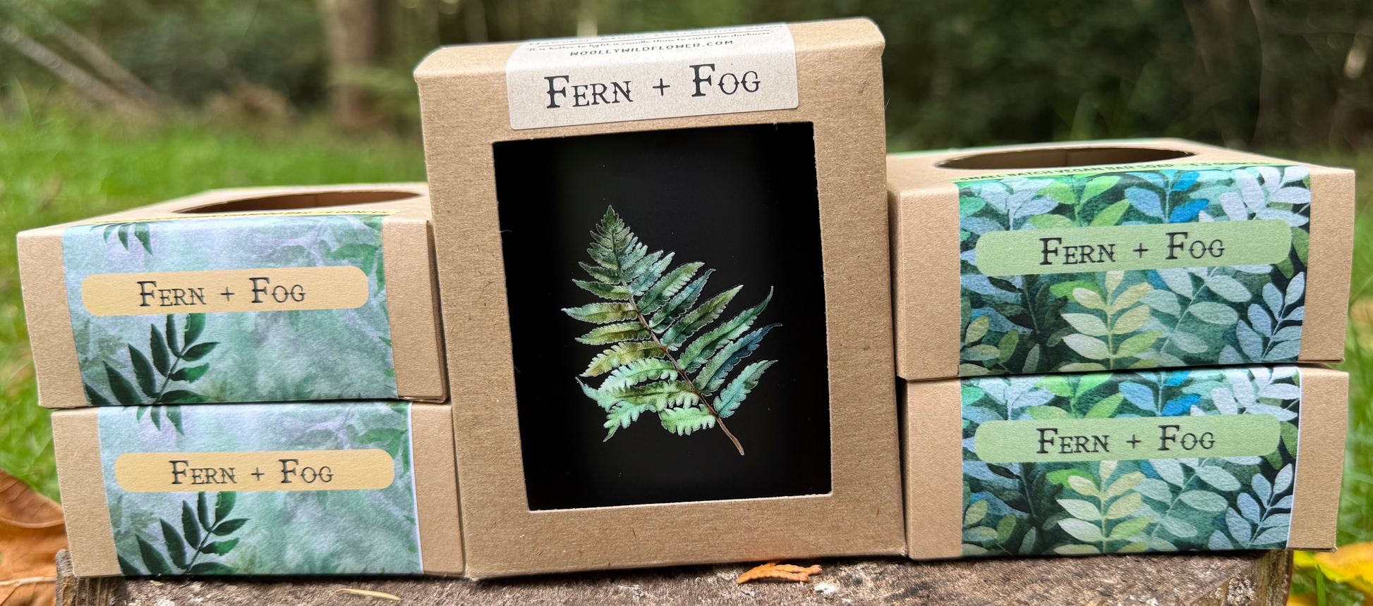Fern + Fog product packaging on a wooden stump with a natural background