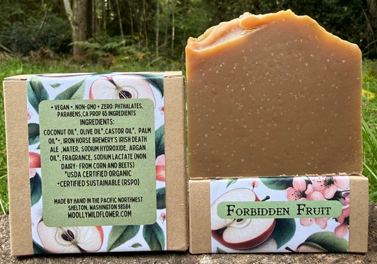Bar of soap with packaging labeled 'Forbidden Fruit' on a natural background