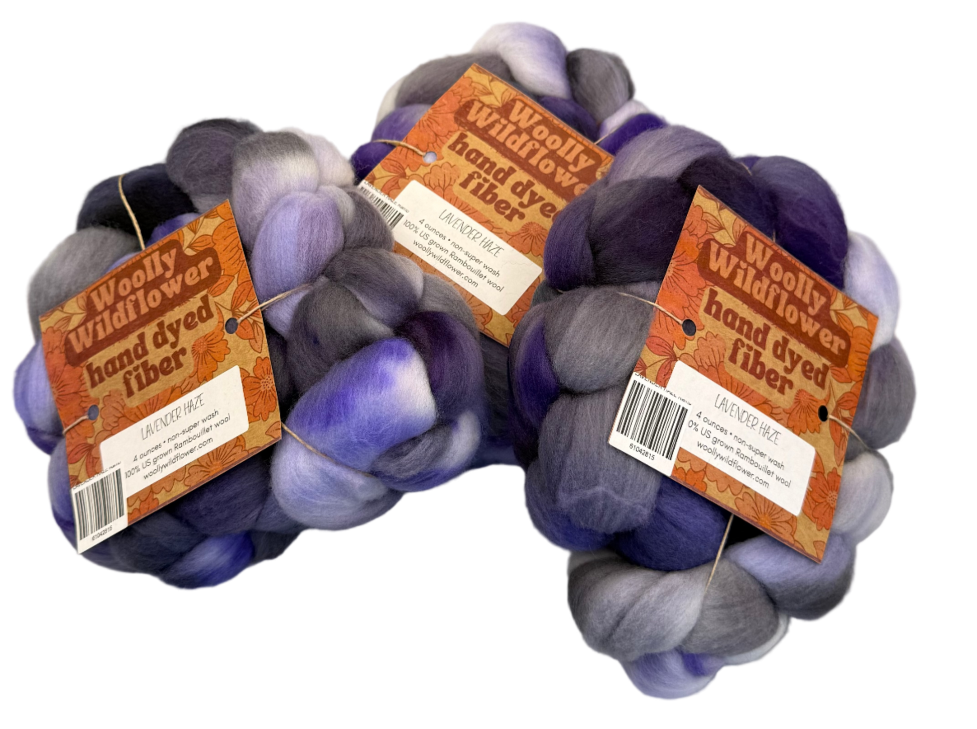 Three skeins of hand-dyed fibers with tags on a gray background