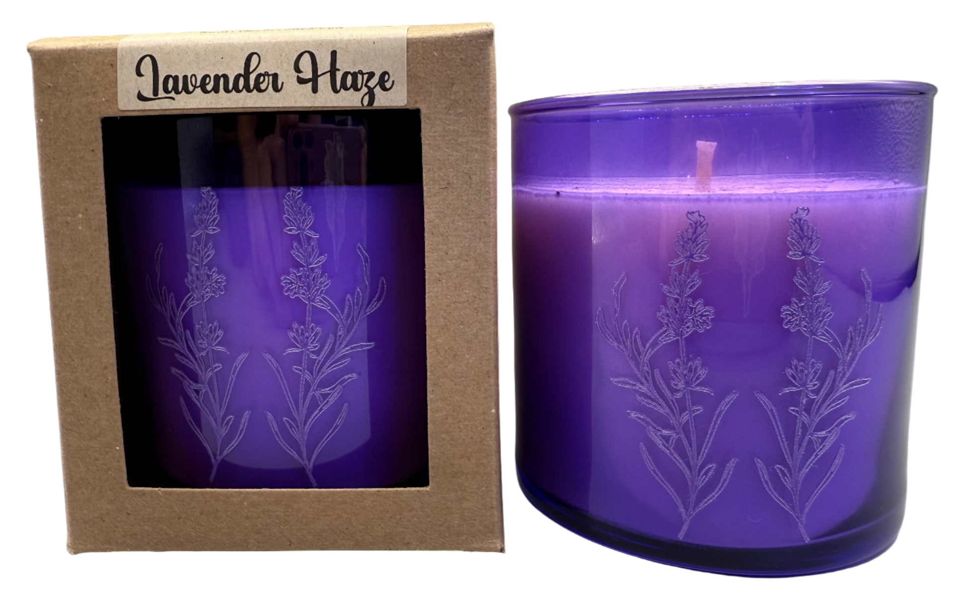 Purple candle with lavender design in packaging labeled 'Lavender Haze' on a gray background