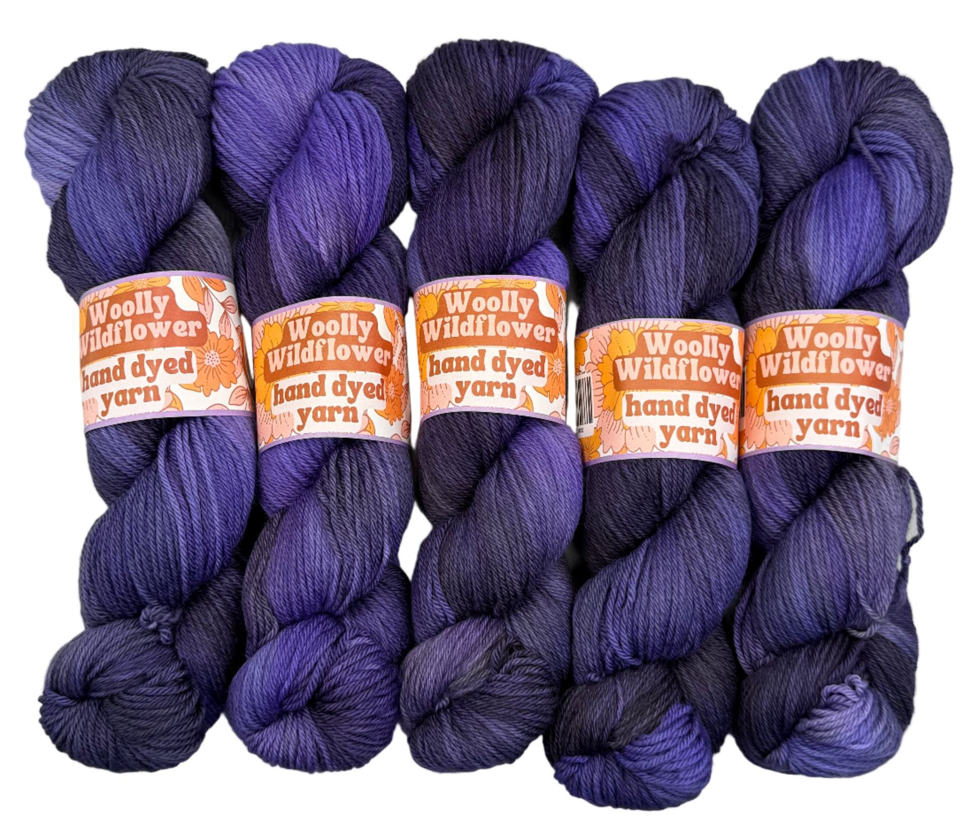 Five skeins of purple yarn with 'Woolly Wildflowers' labels on a white background