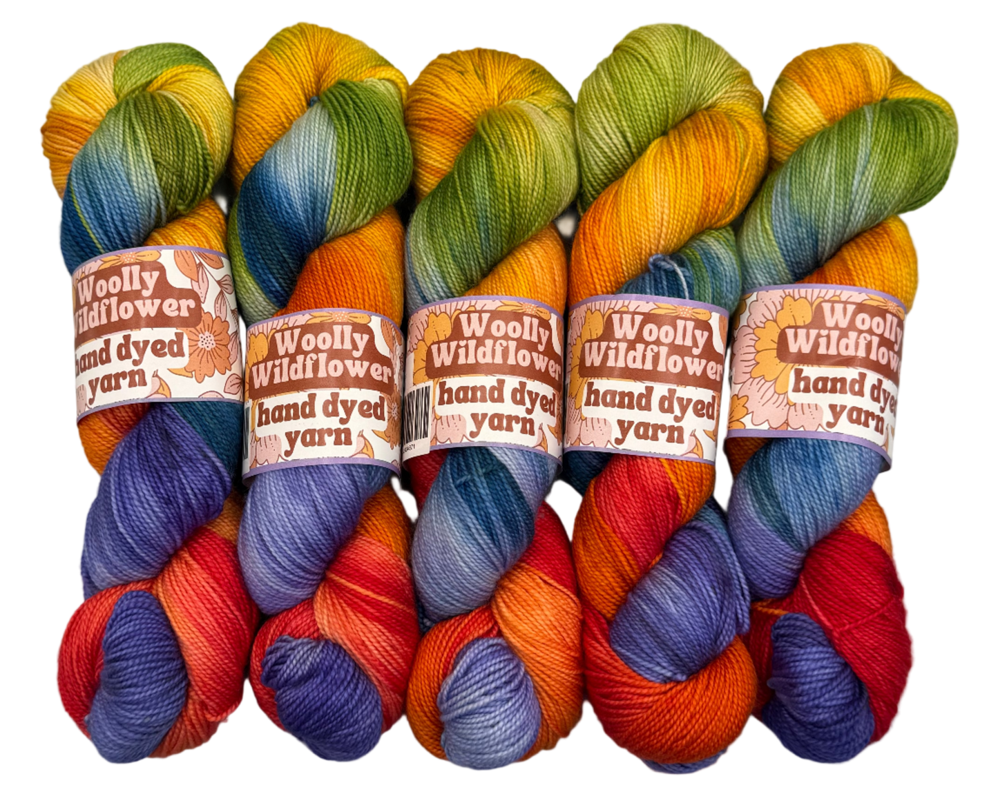 Five skeins of colorful hand-dyed yarn with 'Woolly Wildflower' labels on a light gray background.