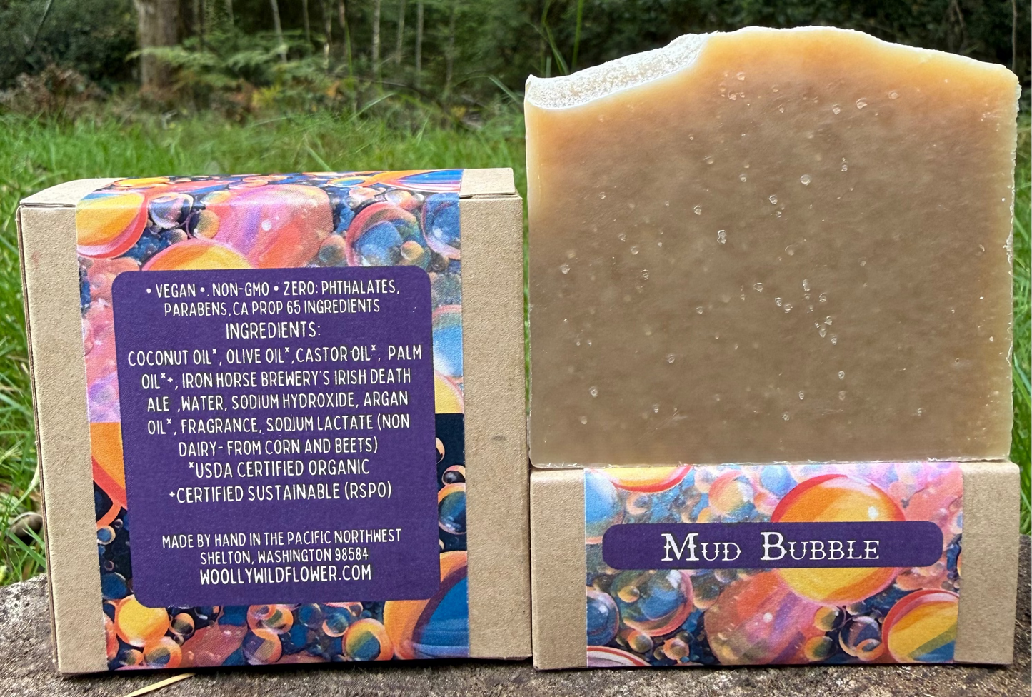 Bar of soap with colorful packaging and label in a natural setting