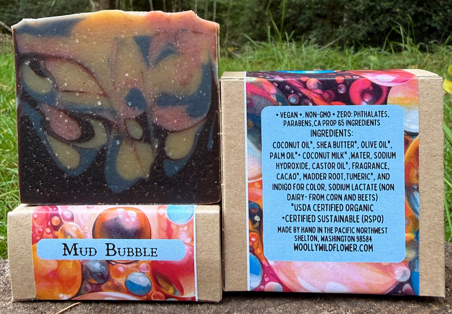 Bar of soap with colorful packaging and butterfly design in a natural setting