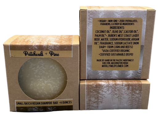 Vegan shampoo bar in packaging with visible label on a gray background
