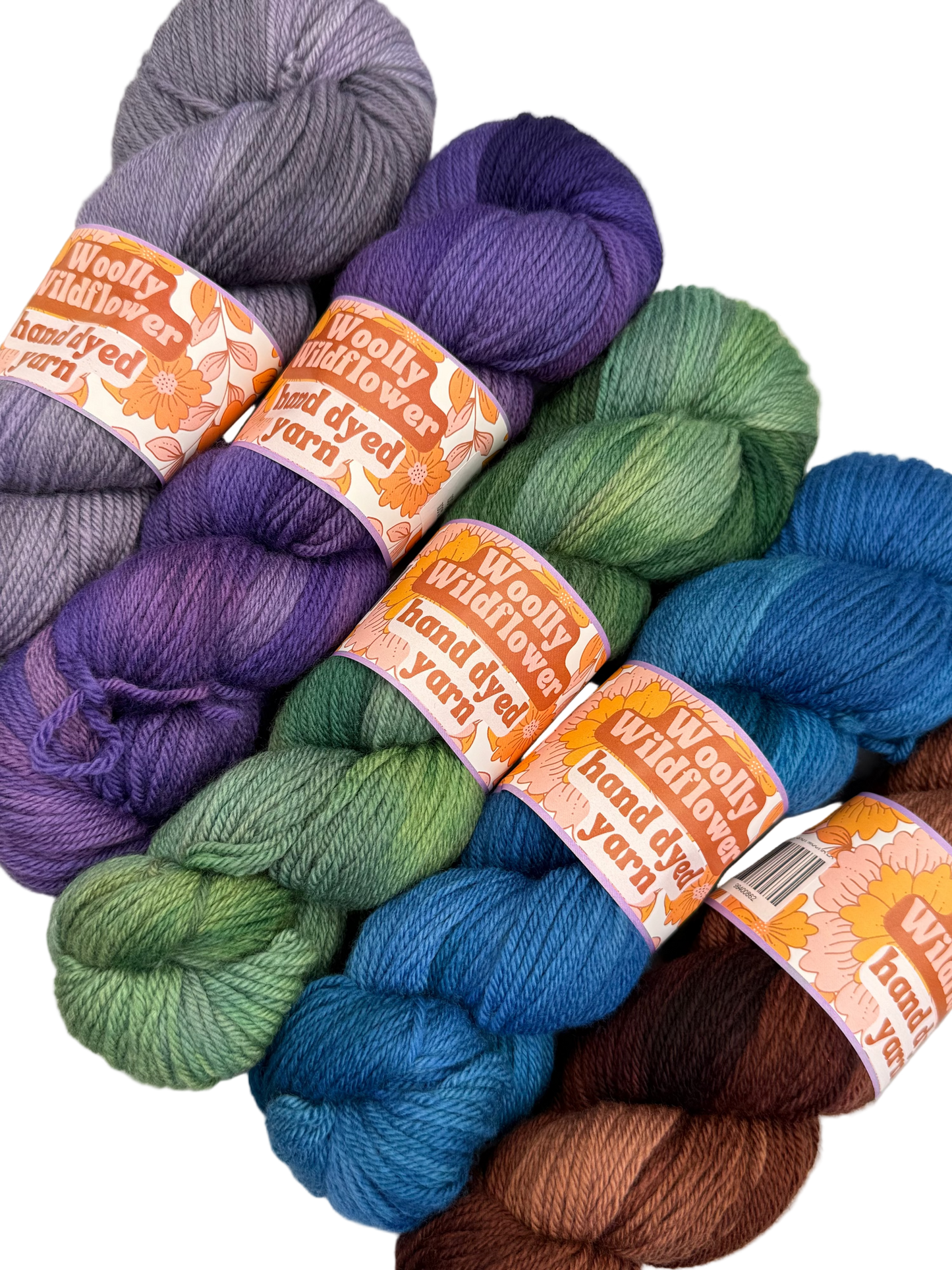 Assorted skeins of colorful yarn with 'Woolly Willows' labels on a white background