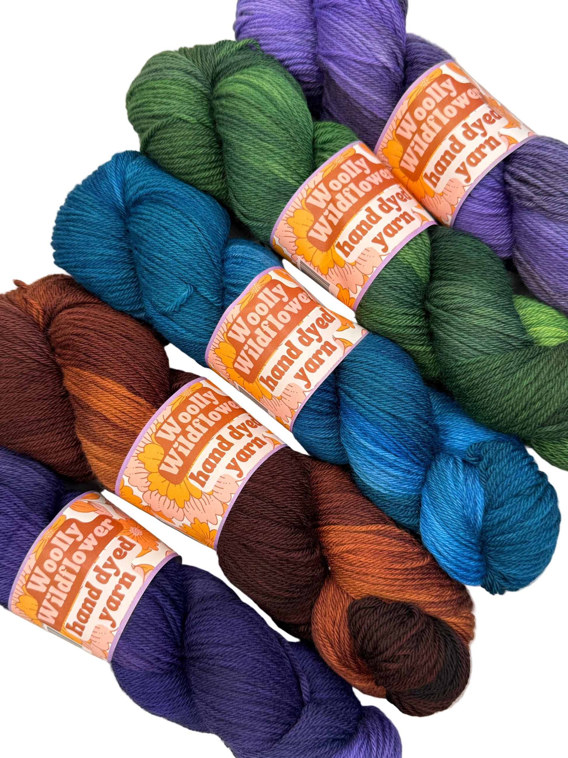 Colorful yarn skeins with labels on a light background