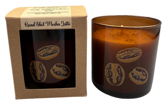 Brown glass candle with decorative elements next to a cardboard box on a white background