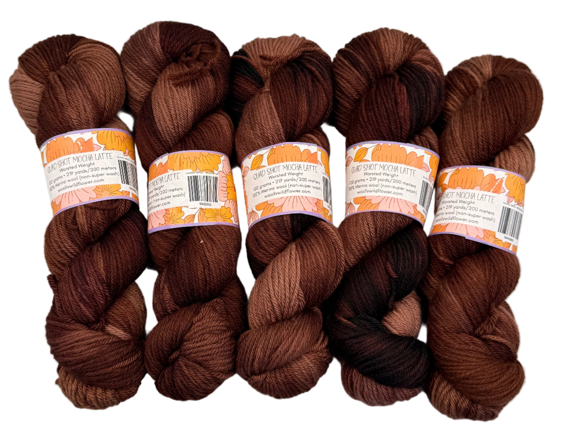 Five skeins of brown yarn with labels on a light gray background