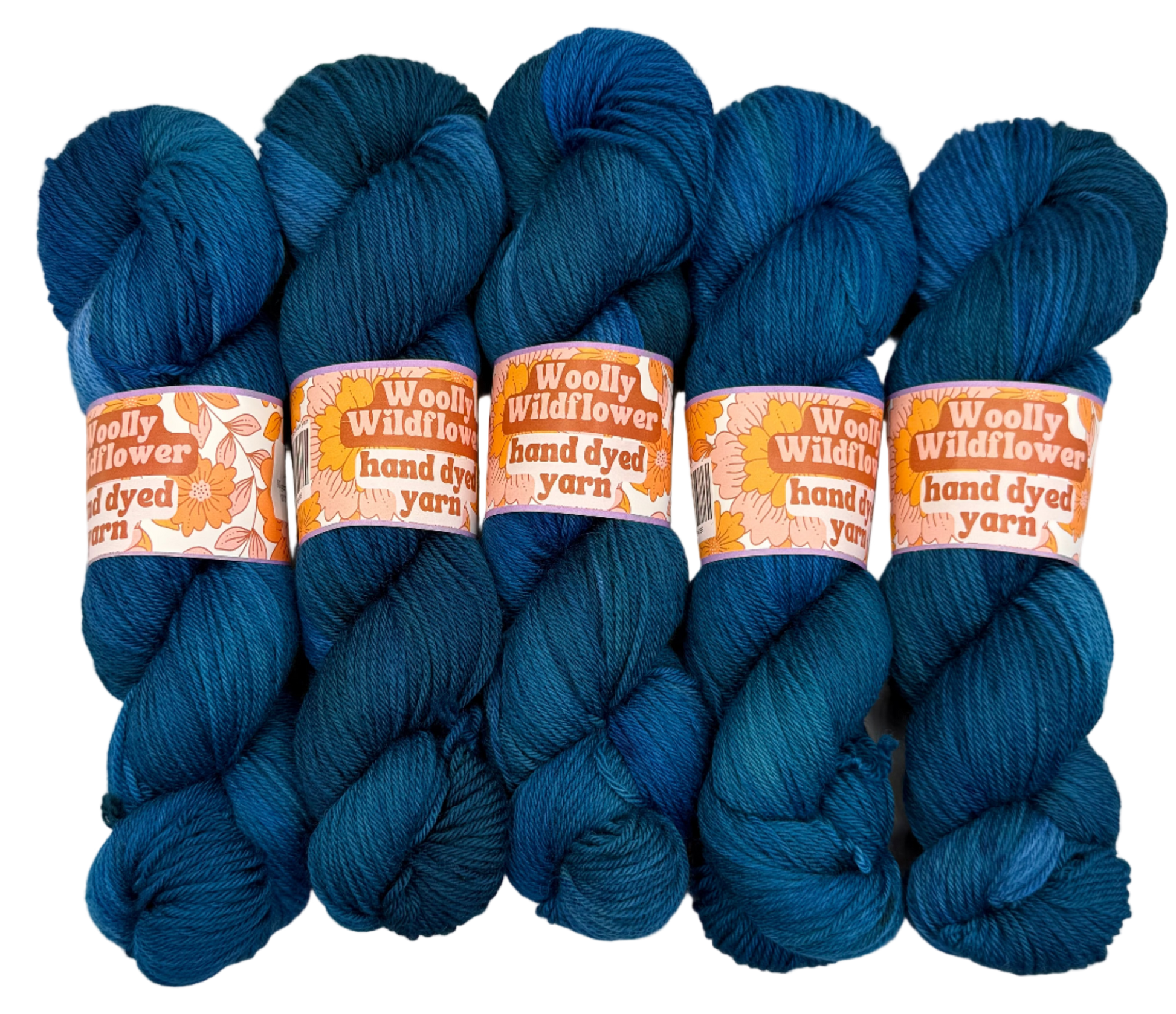 Five skeins of blue yarn with 'Woolly Wildflower' labels on a white background