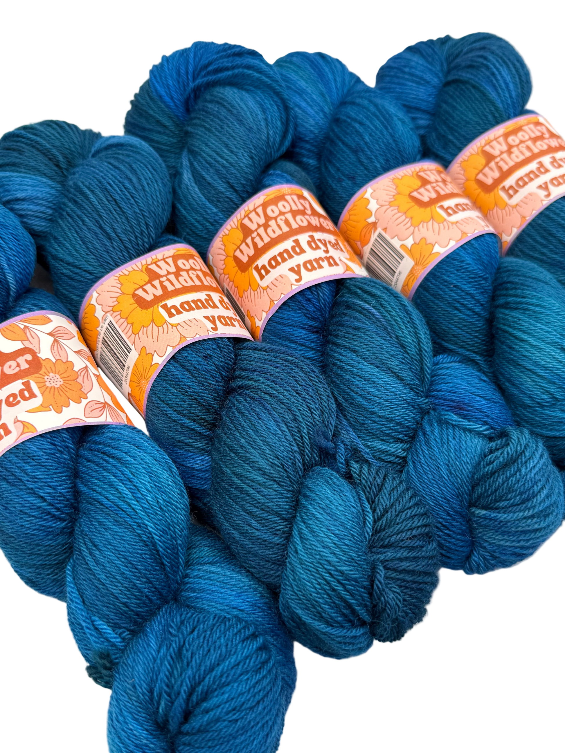 Blue yarn skeins with 'Woolly Willows' labels on a white background