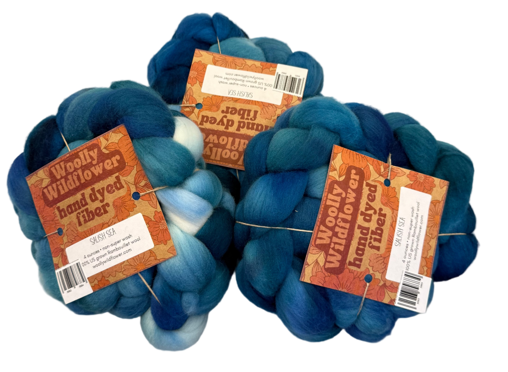 Three skeins of blue fiber with labels on a gray background