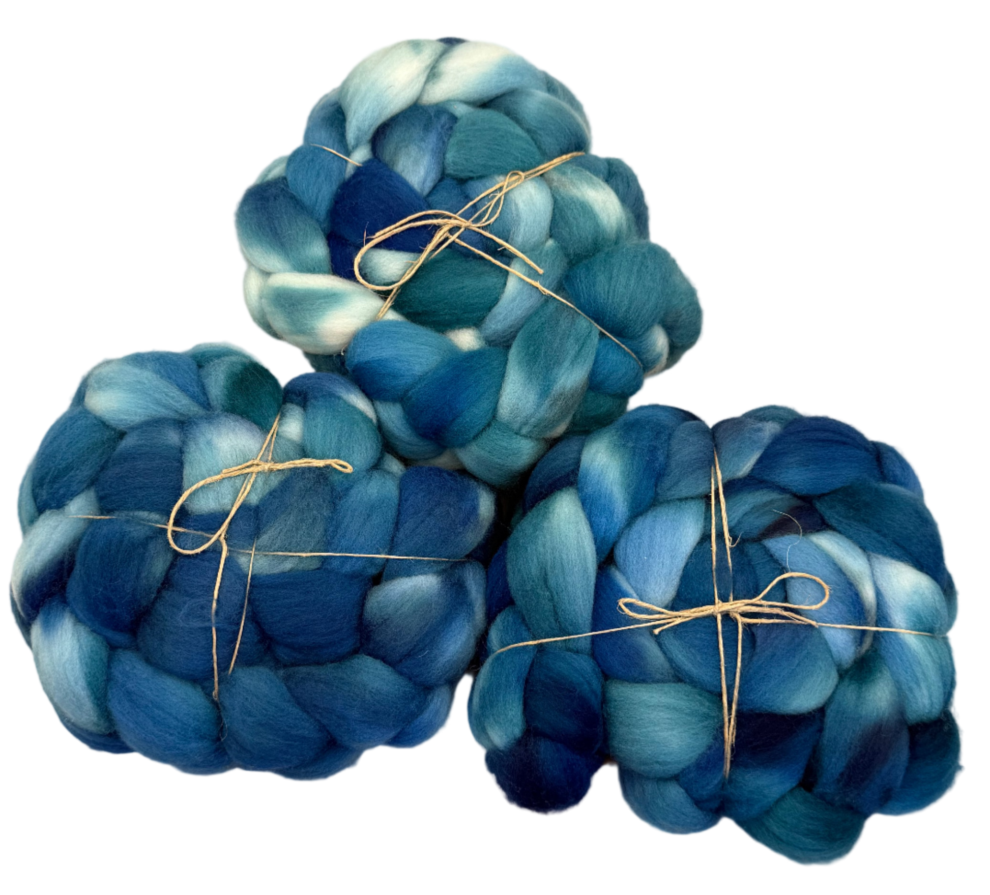 Three skeins of blue and green fibers tied with string on a light background