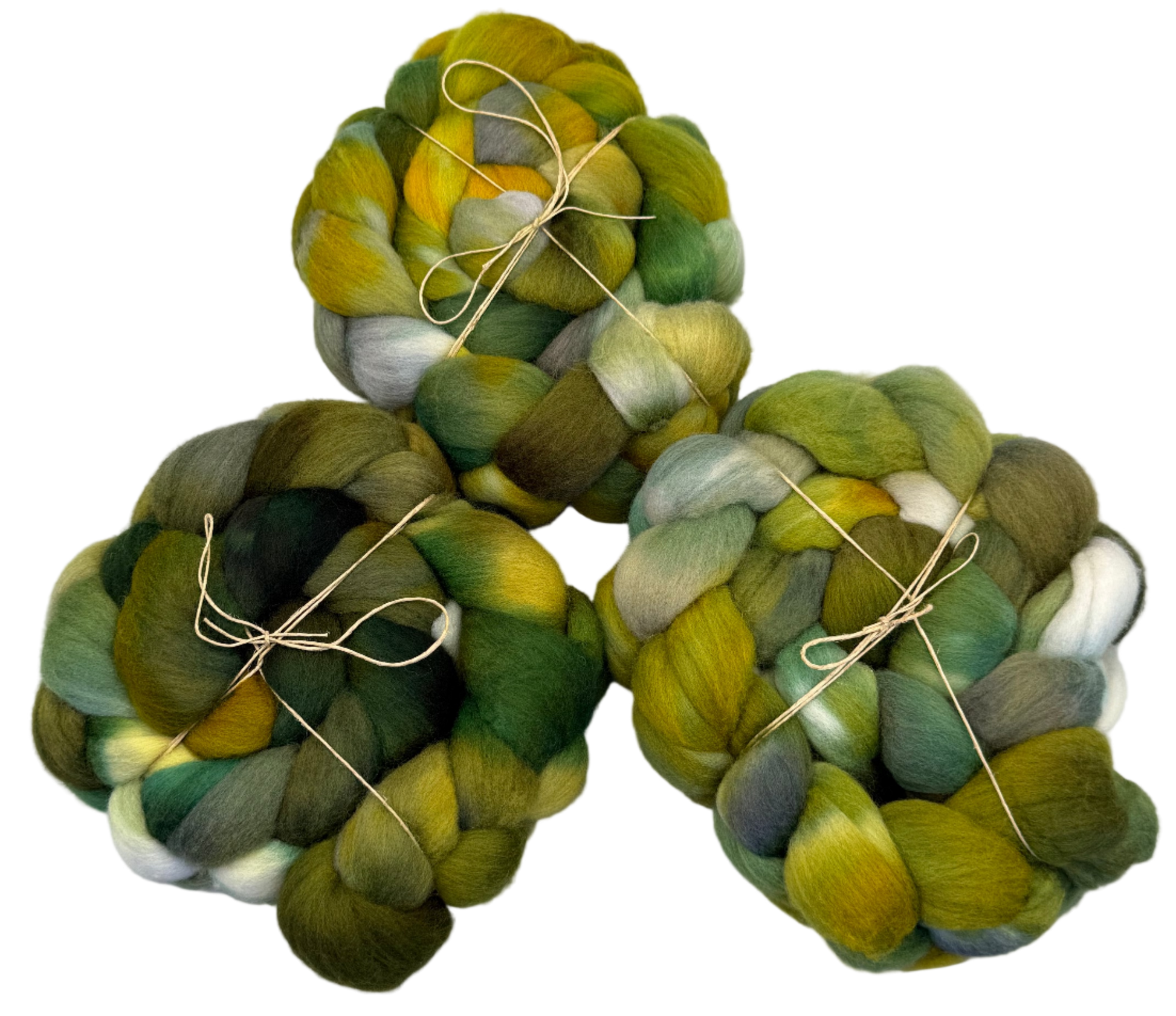 Three skeins of green and yellow fibers tied with twine on a white background