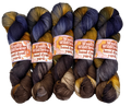 Five skeins of hand-dyed yarn in brown, blue, and orange on a white background with 'Woolly Wildflower' labels.