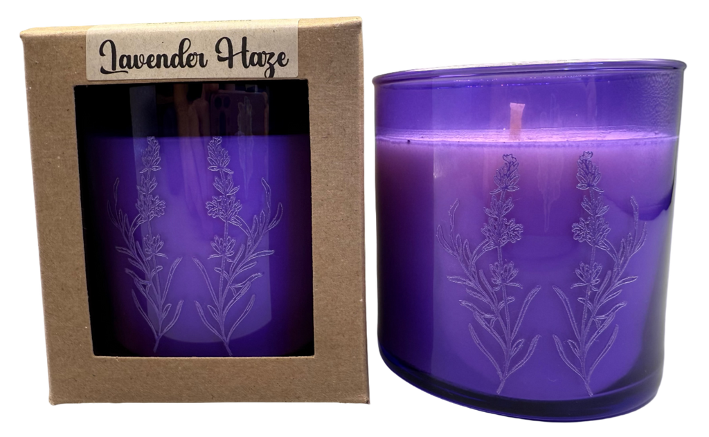 Purple candle with lavender design in packaging labeled 'Lavender Haze' on a gray background