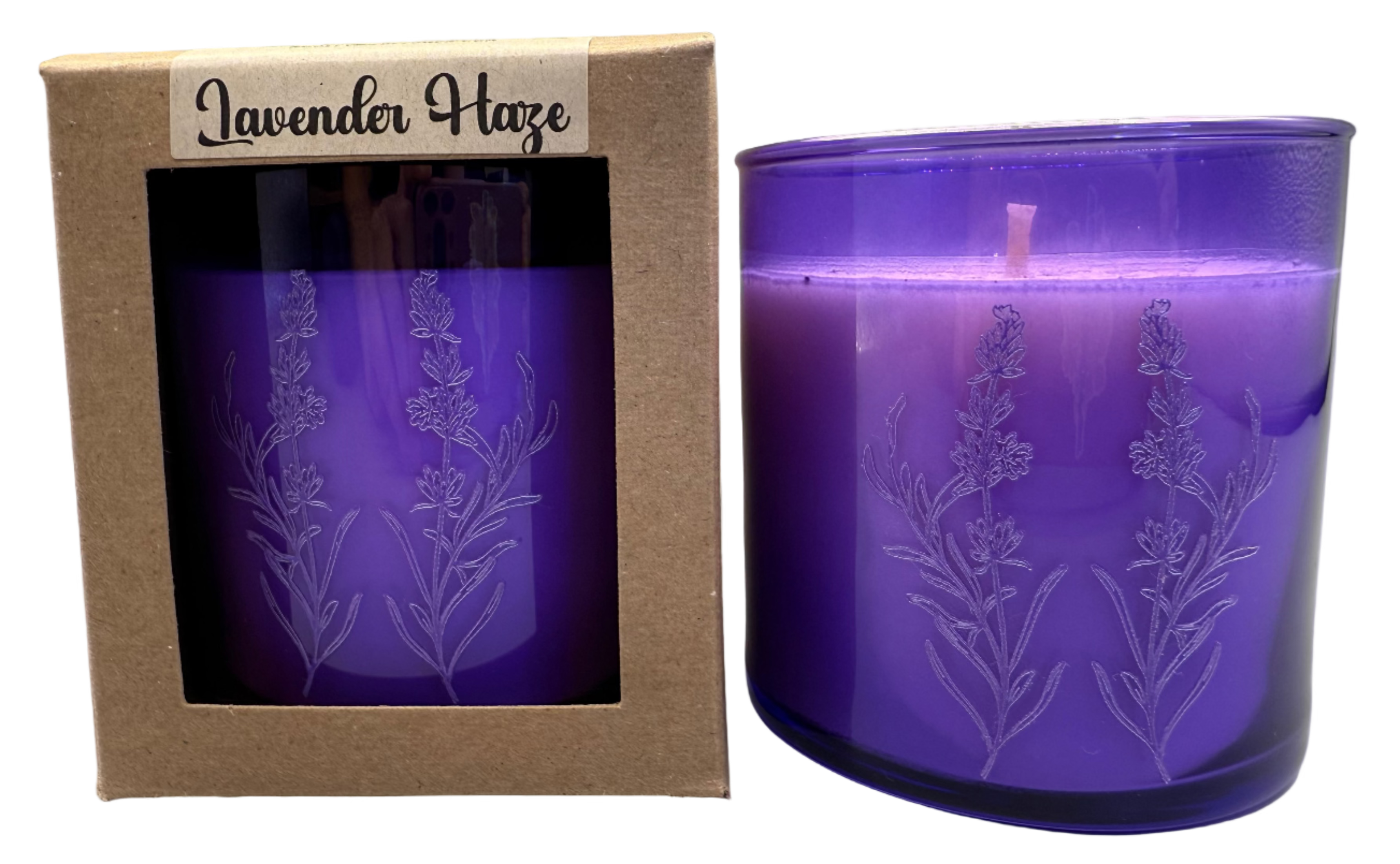 Purple candle with lavender design in packaging labeled 'Lavender Haze' on a gray background