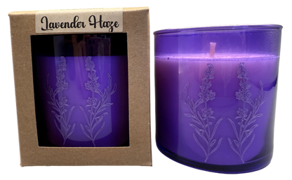 Purple candle with lavender design in packaging labeled 'Lavender Haze' on a gray background