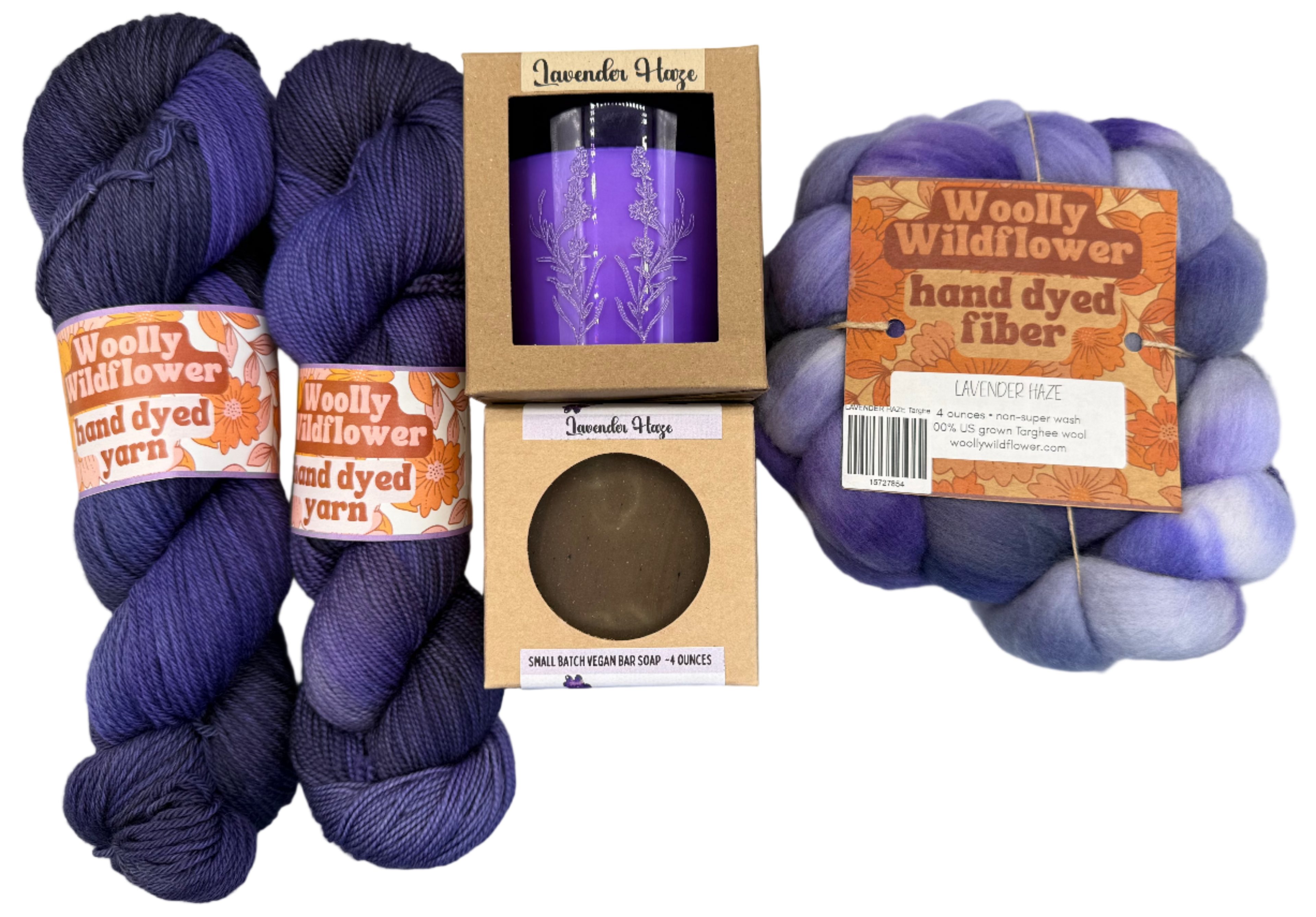 Two skeins of purple yarn, a purple tumbler, and a ball of hand-dyed fiber on a gray background.