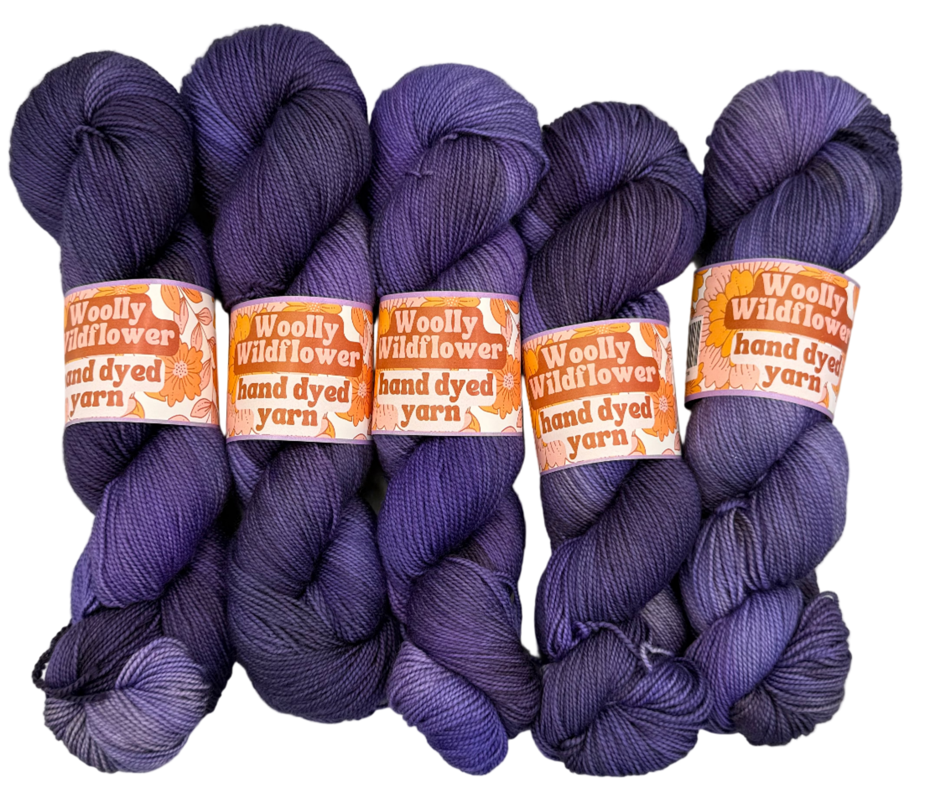Four skeins of purple yarn with orange labels on a light gray background