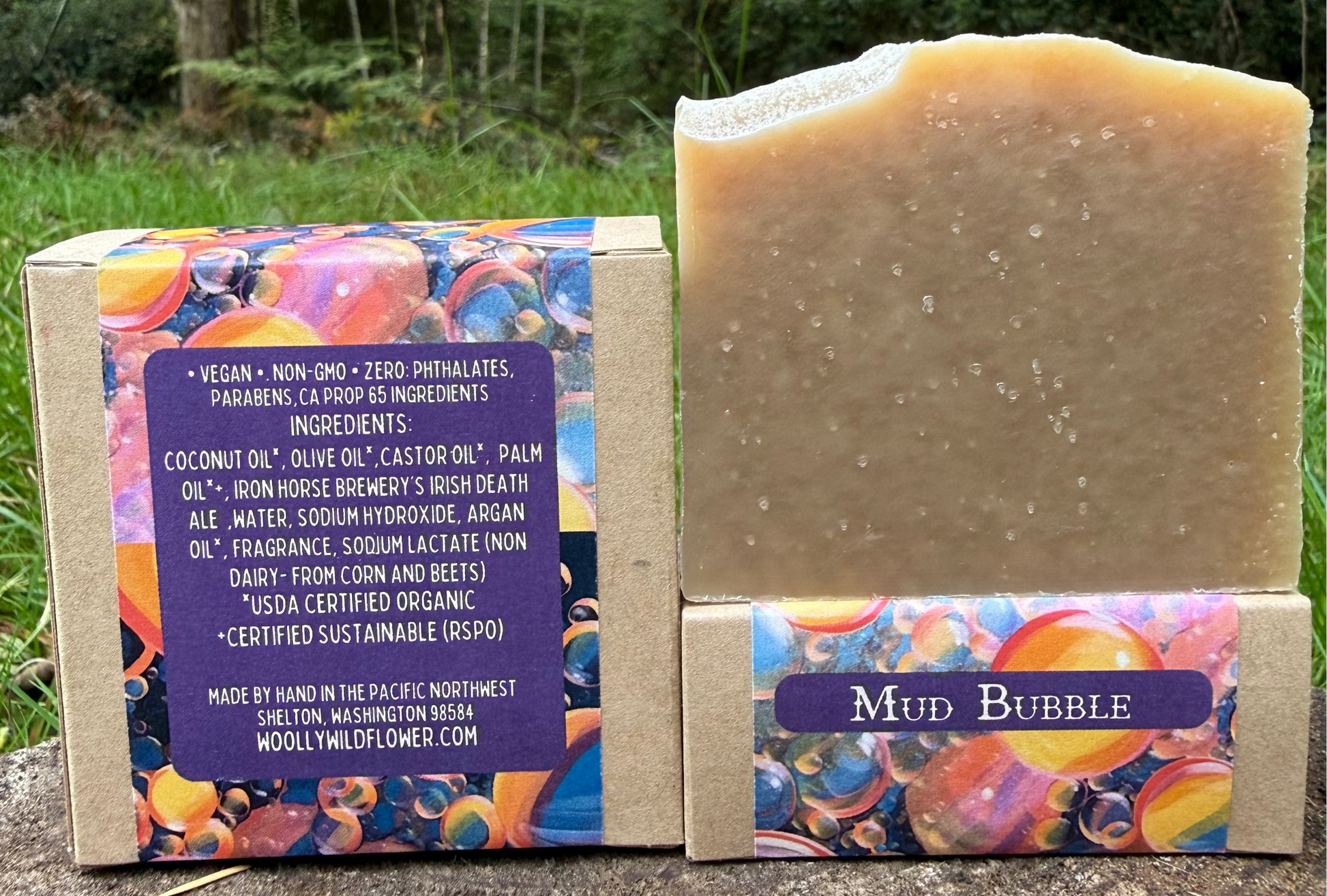 Bar of soap with colorful packaging and label in a natural setting