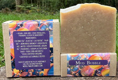 Bar of soap with colorful packaging and label in a natural setting