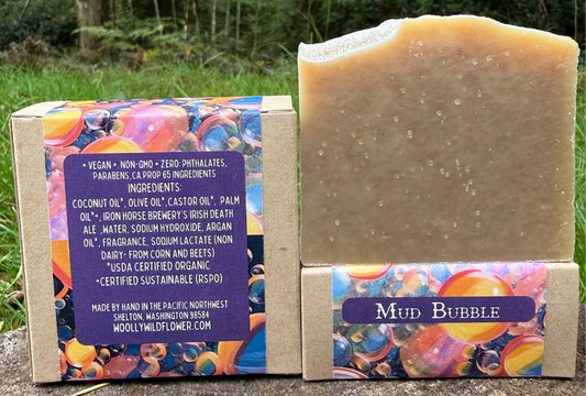 Bar of soap with colorful packaging and label in a natural setting