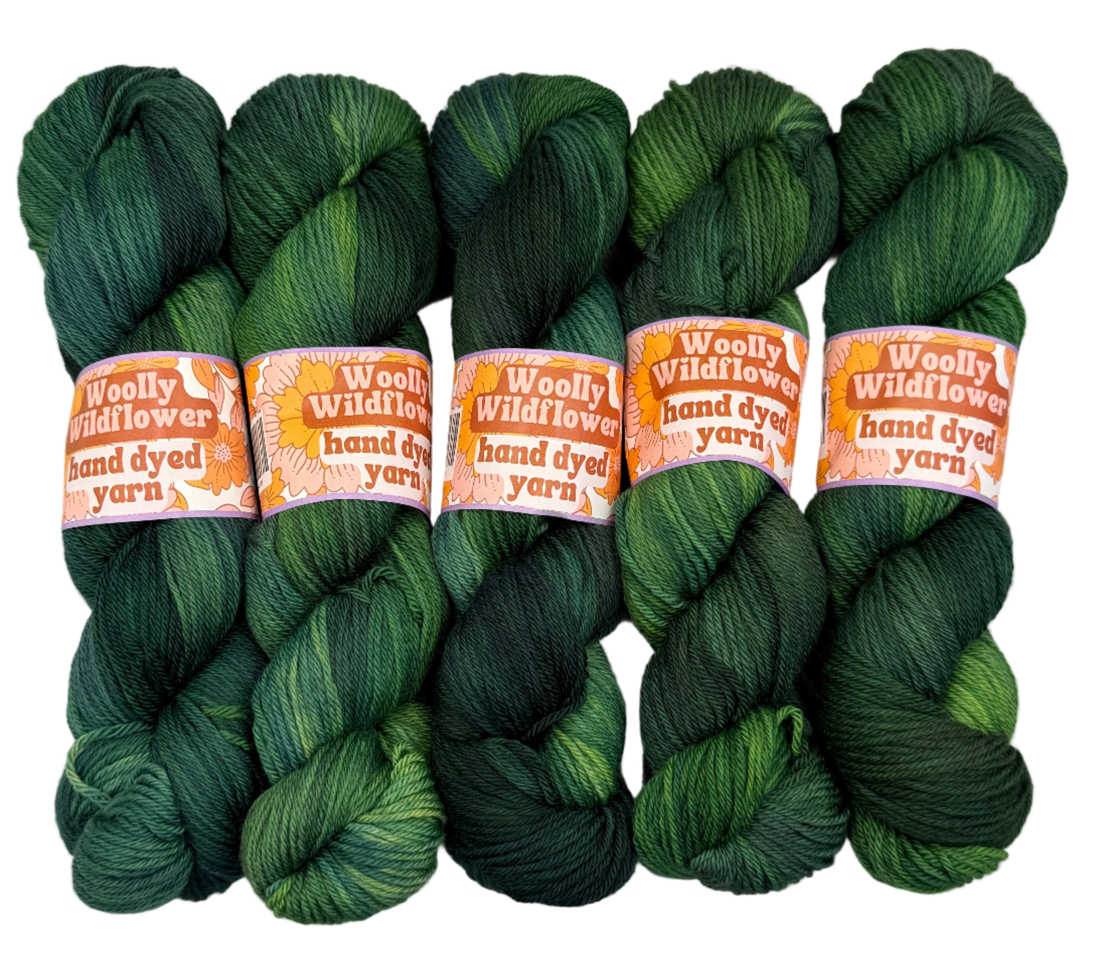 Five skeins of green hand-dyed yarn with 'Woolly Wildflower' labels on a white background.