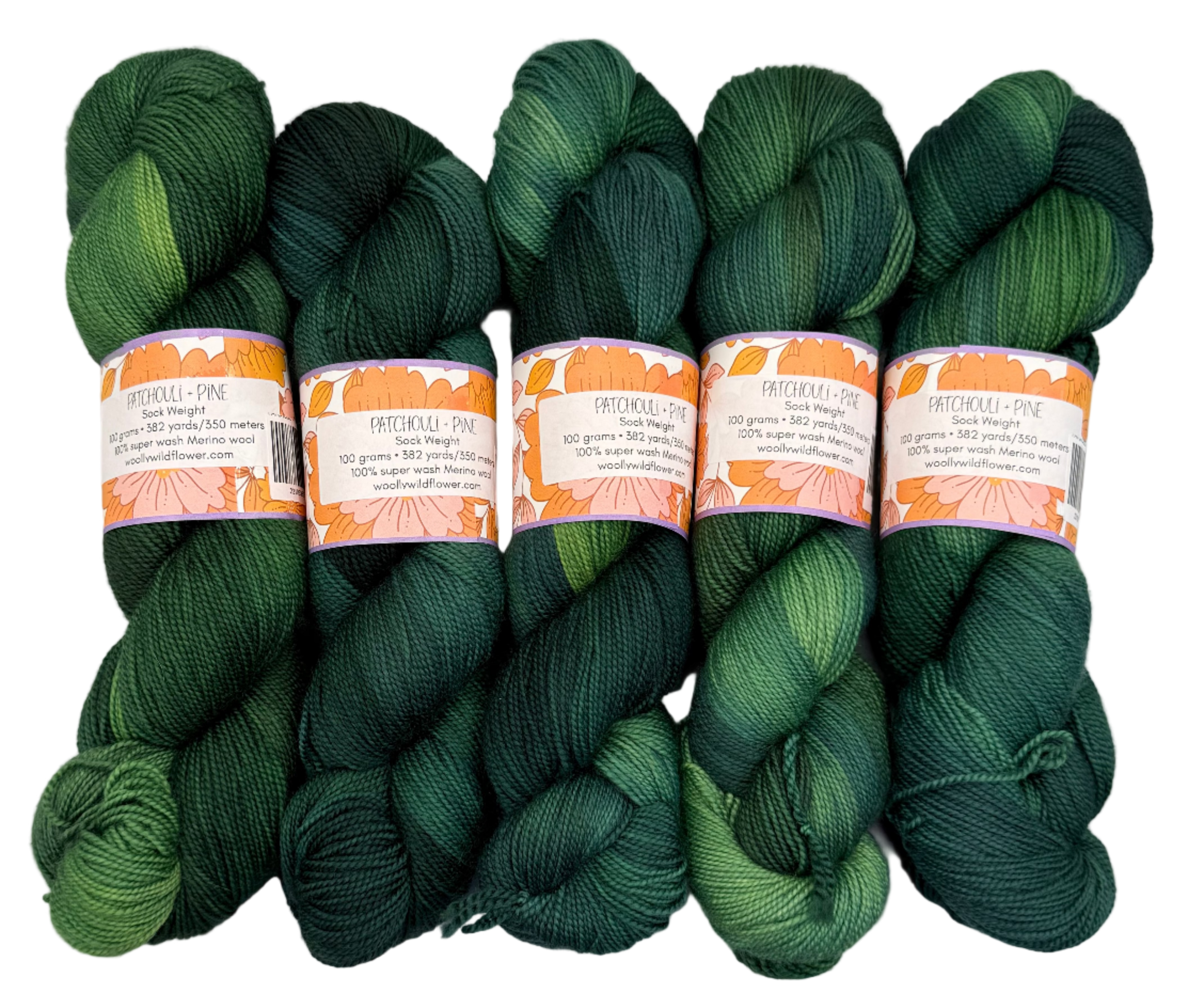 Five skeins of green yarn with labels on a white background