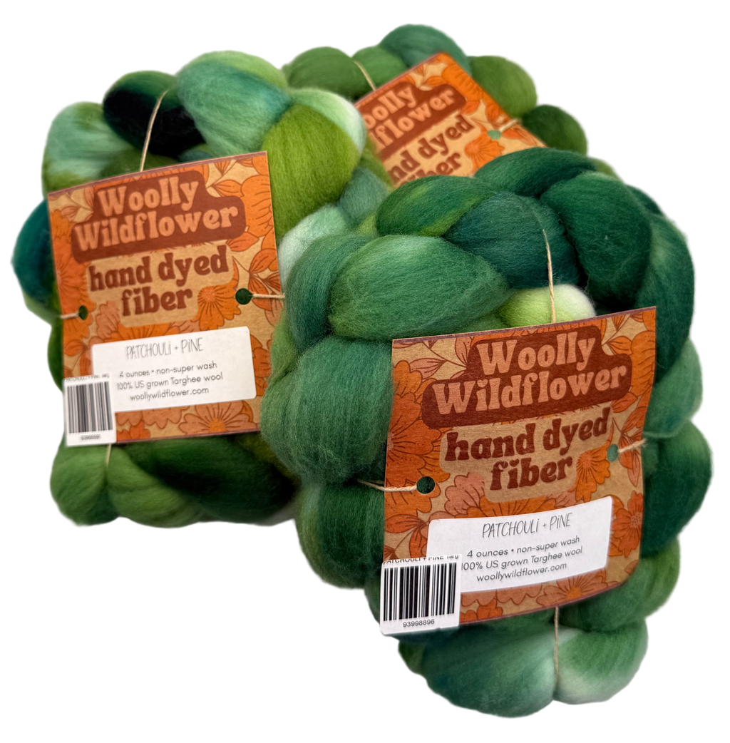 Three braids of green hand-dyed fiber with 'Woolly Wildflower' labels on a light gray background.