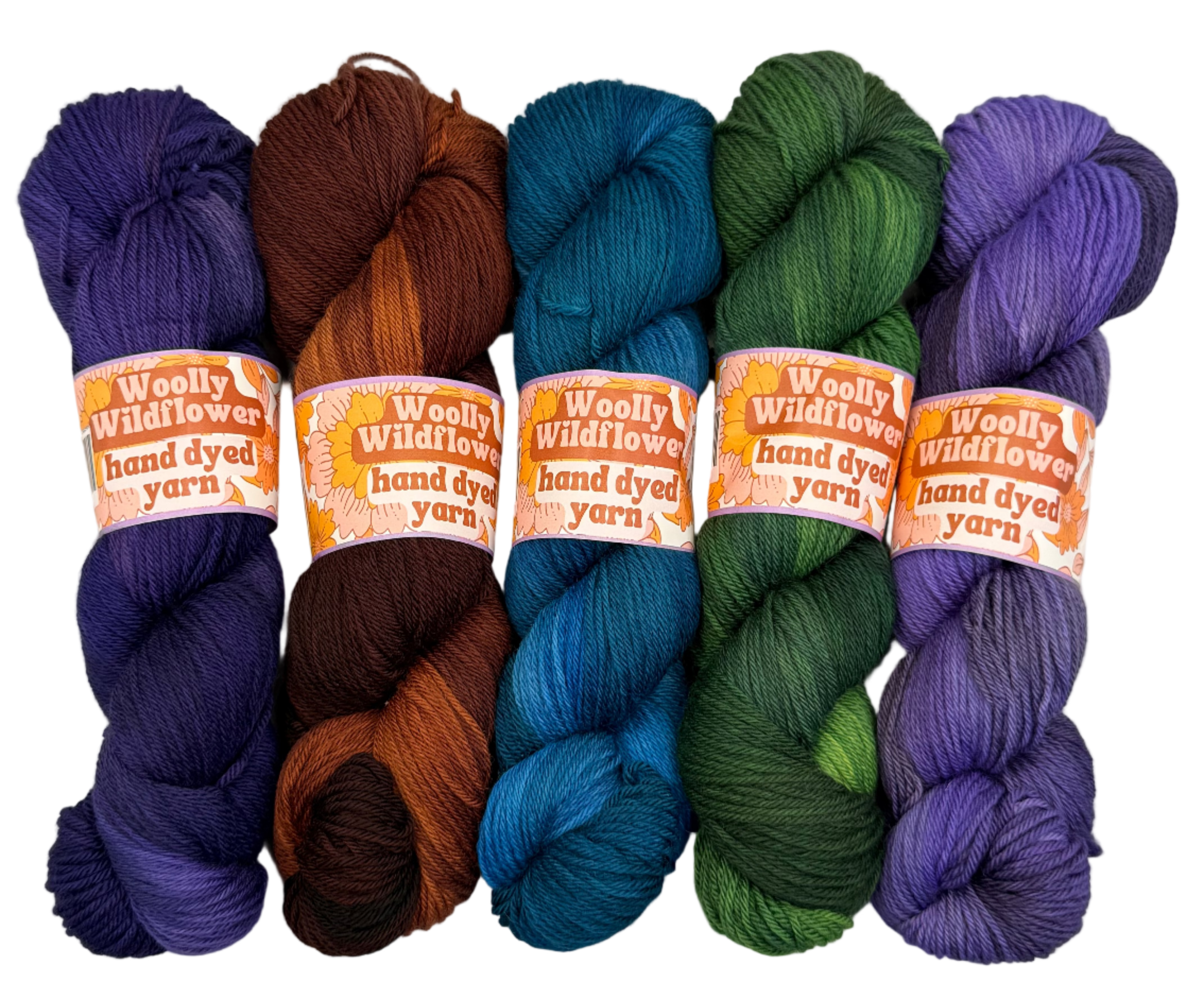 Five skeins of hand-dyed yarn in purple, brown, blue, green, and purple on a white background with 'Woolly Wildflowers' labels.