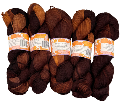 Five skeins of brown yarn with labels on a white background