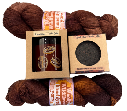 Brown yarn skeins with branded packaging on a light gray background