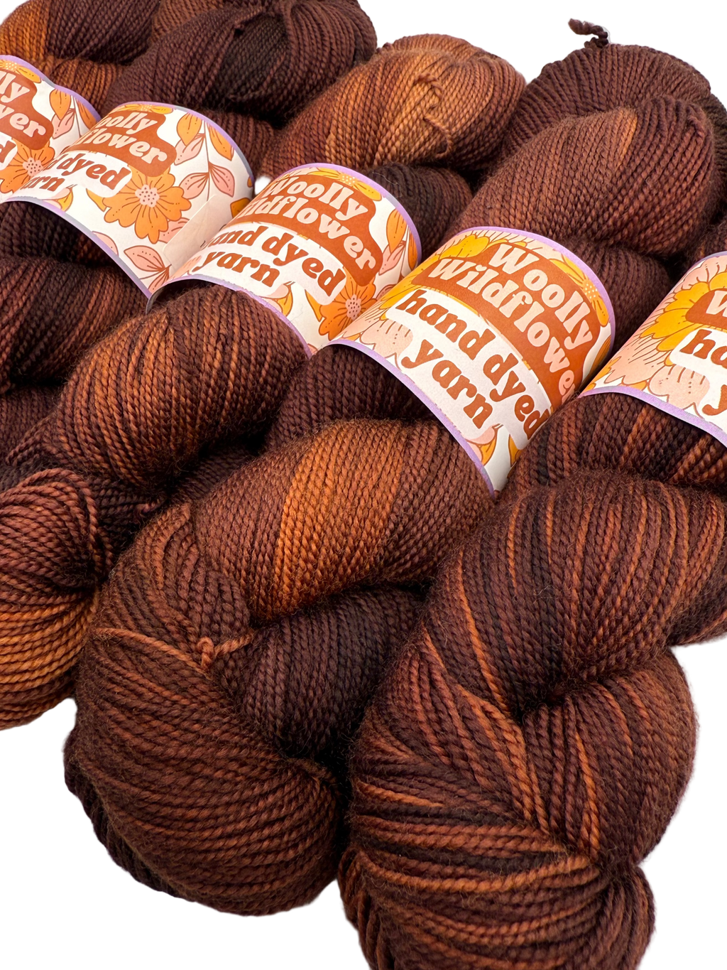 Brown yarn skeins with labels on a white background