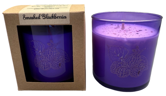 Purple candle in a decorative box with 'Smashed Blackberries' label on a white background