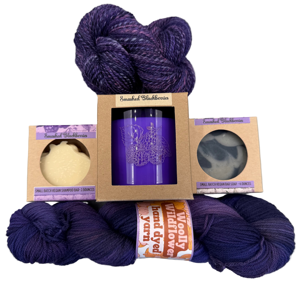 Purple yarn skeins with packaging on a gray background