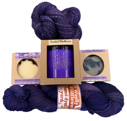 Purple yarn skeins with packaging on a gray background