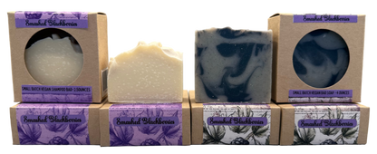 Three soaps with packaging on a gray background