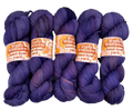Four skeins of purple yarn with 'Woolly Wildflower' labels on a light gray background