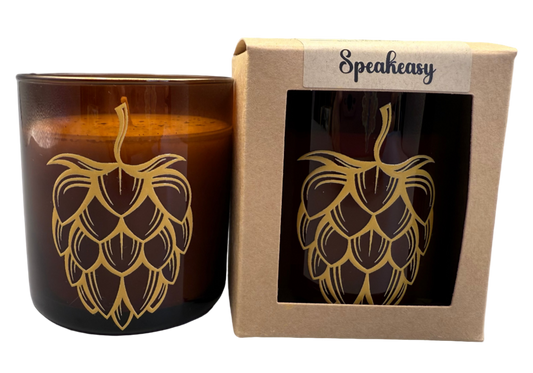 Candle with hop design and Speakeasy packaging on a white background
