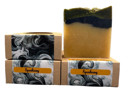Two stacked soap bars with Speakeasy branding on a gray background