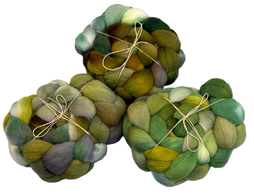 Three skeins of multicolored yarn tied together on a white background