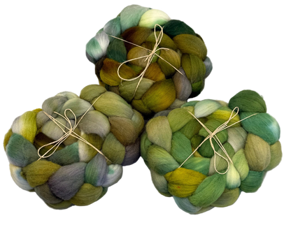 Three skeins of multicolored yarn tied together on a white background